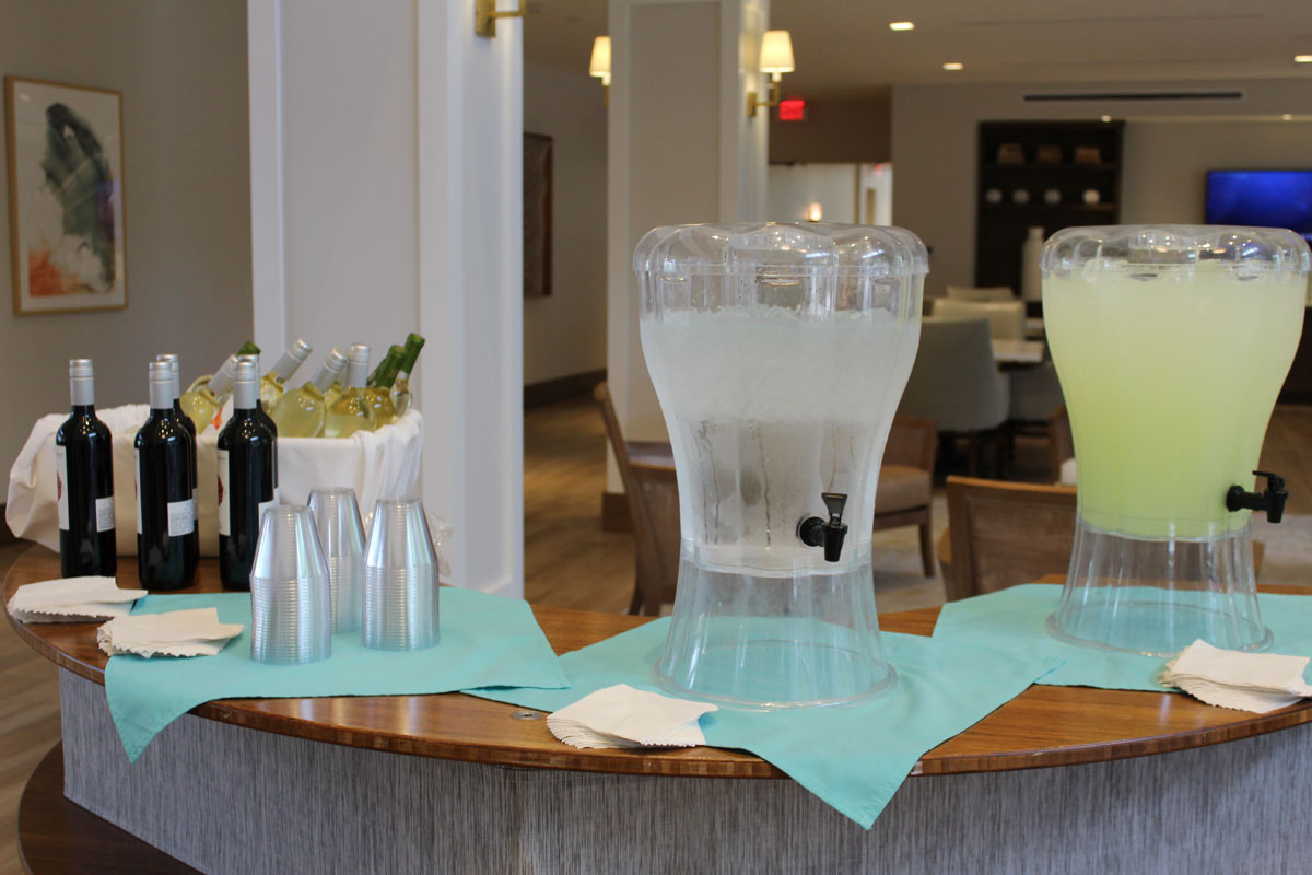 Water, lemonade, and wine for fashion show guests and residents
