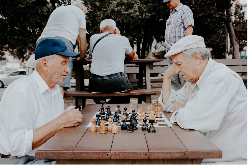 Two men playing chess at Amavida