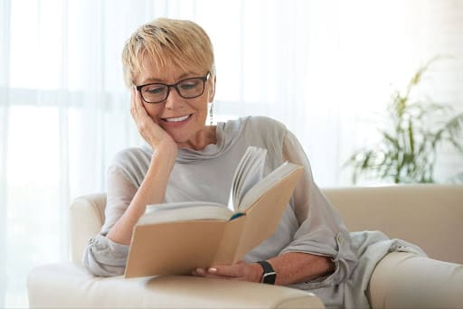 senior-woman-reading-an-essential-book-on-aging-well