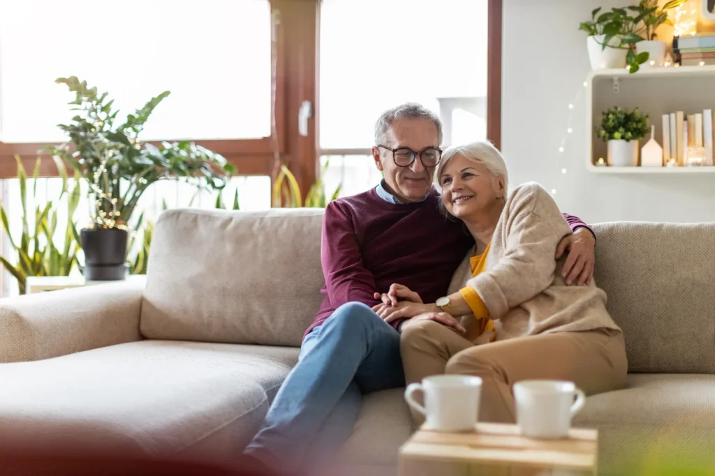 elderly couple relaxing together on the sofa